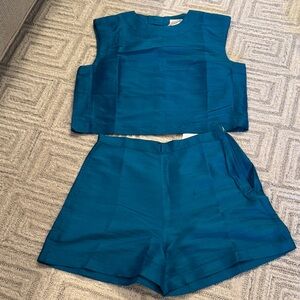 Julia Amory iridescent teal slim Shell top and kelly short in Dupioni silk.